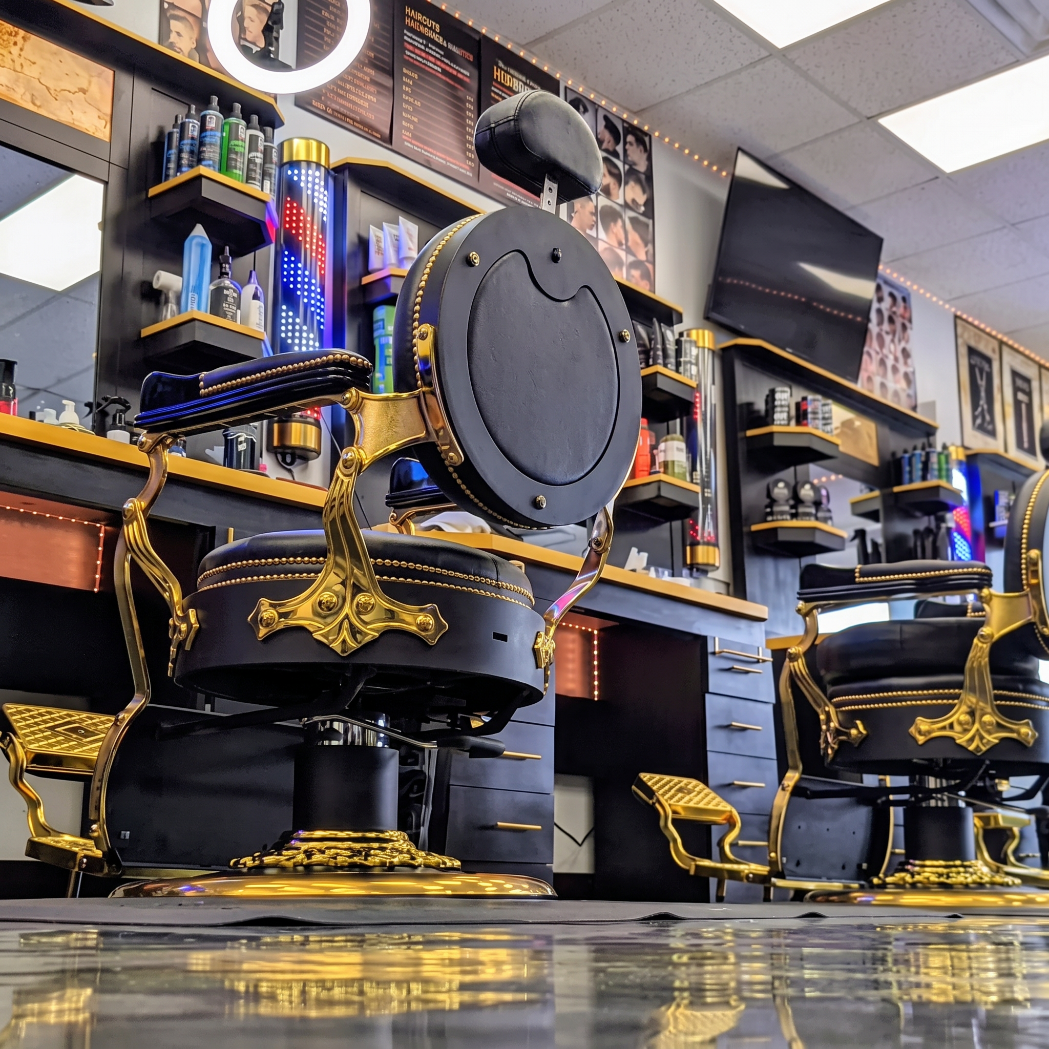 Gold barber chairs with navy upholstery inside Top Trend Barbershop in Sylvania, Ohio